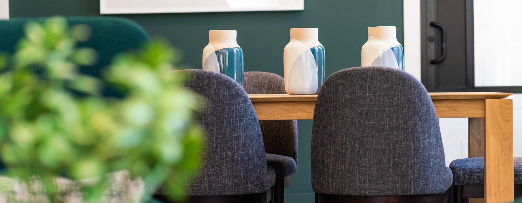 a table with chairs and a plant