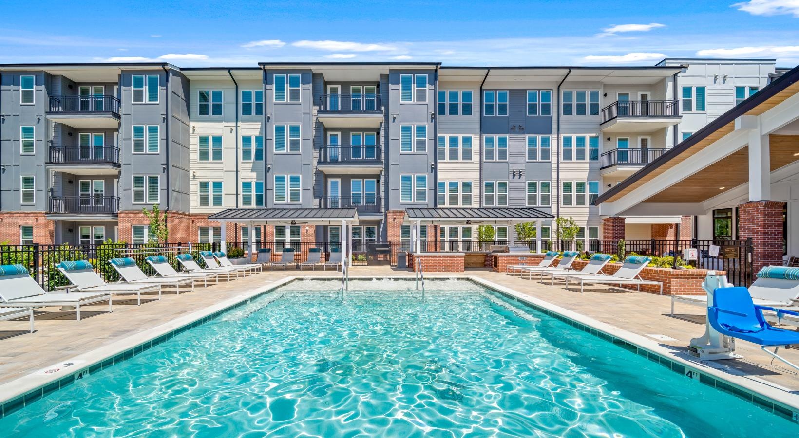 Resort-style swimming pool a swimming pool in front of a large building