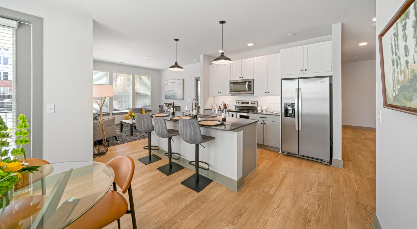 Wide open living areas flooded with natural light a kitchen with a wood floor