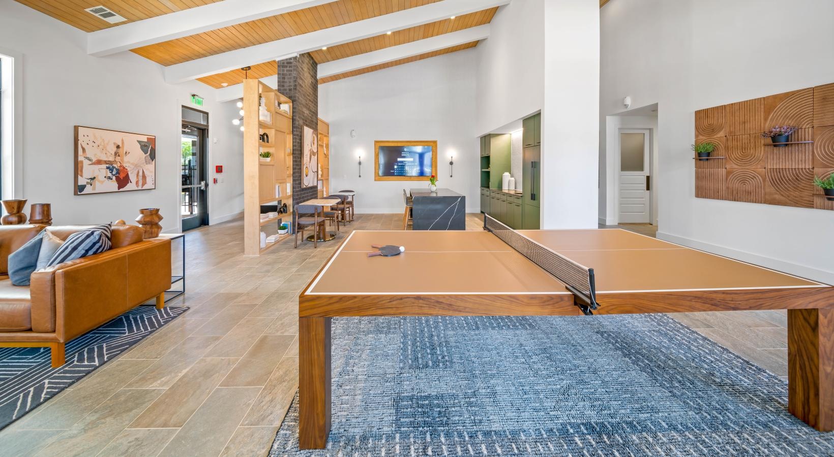 Relax and unwind poolside a large living room with a pool table and a large rug