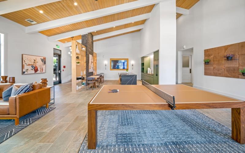 a large living room with a pool table and a large rug