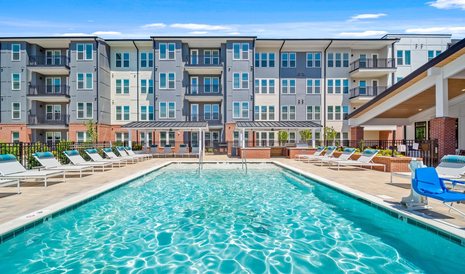 Resort-style swimming pool a swimming pool in front of a large building