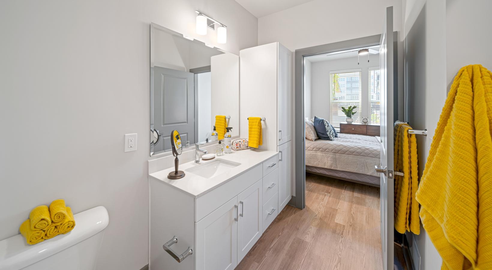 Beautiful bedrooms to fit every need a bathroom with a bed and a sink