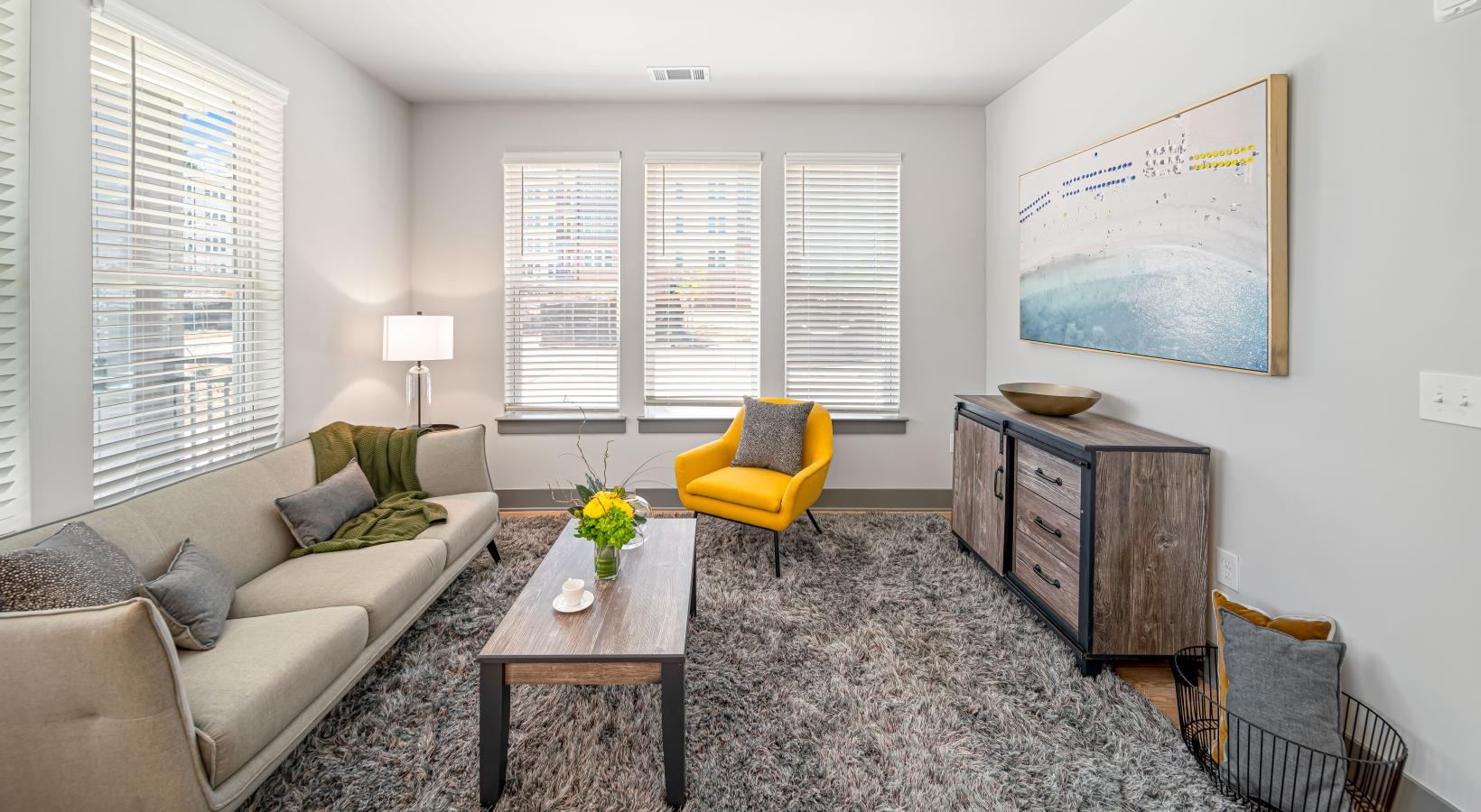 Spacious living areas to recline and recharge a living room with a couch and a table